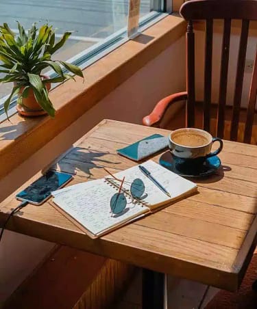 table-with-coffee-and-notebook-with-engaging-social-media-captions