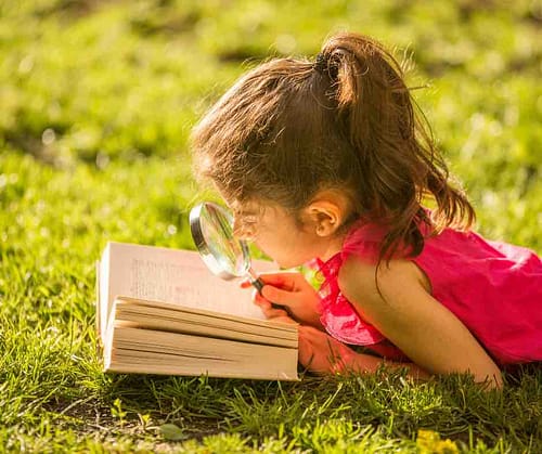 kid-laying-in-the-grass-reading-a-compelling-blog-or-article